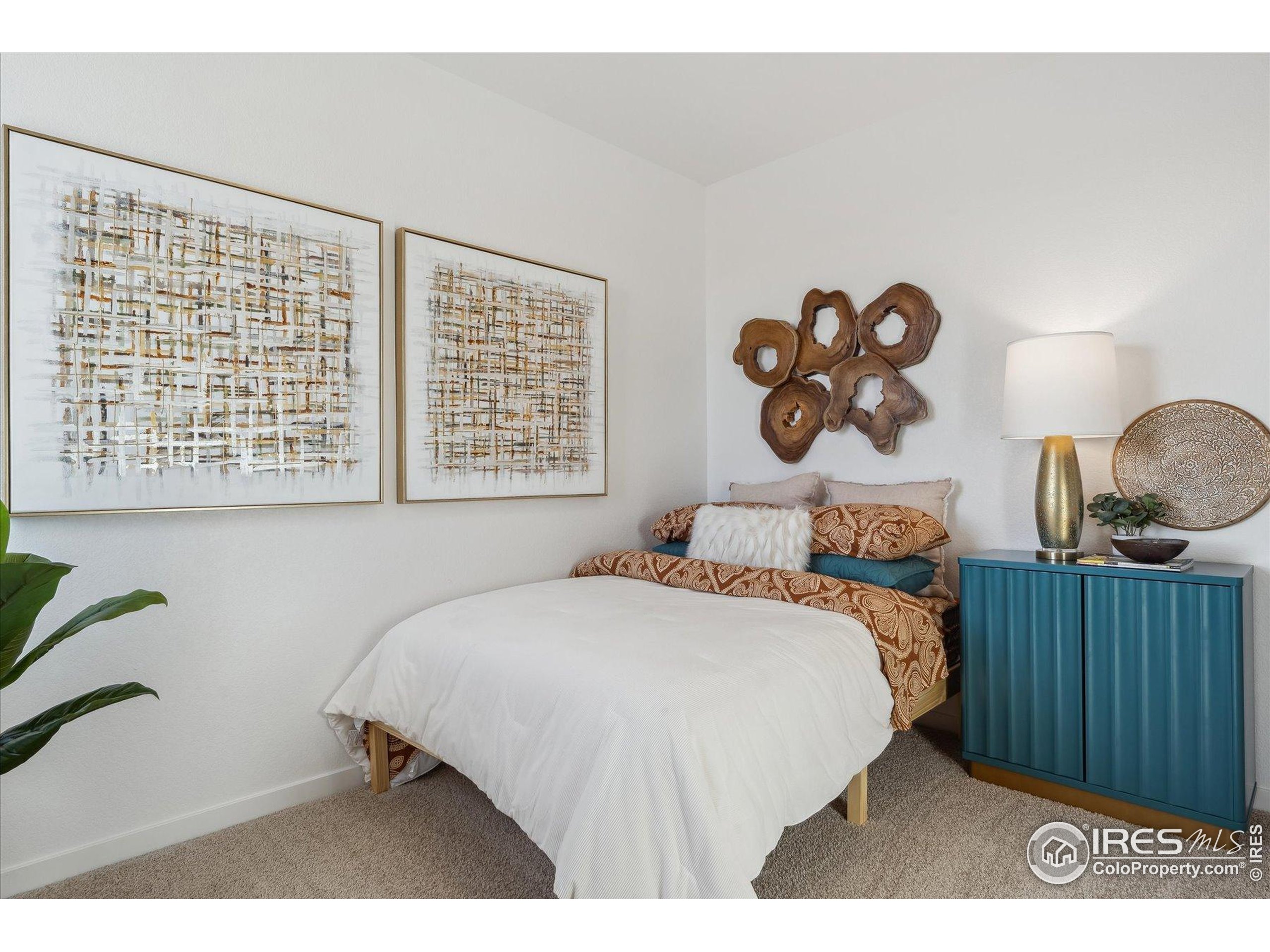 2207 Crosswind Street Fort Lupton, CO 80621 - Photo 22 of 26 a bedroom with a bed and a window