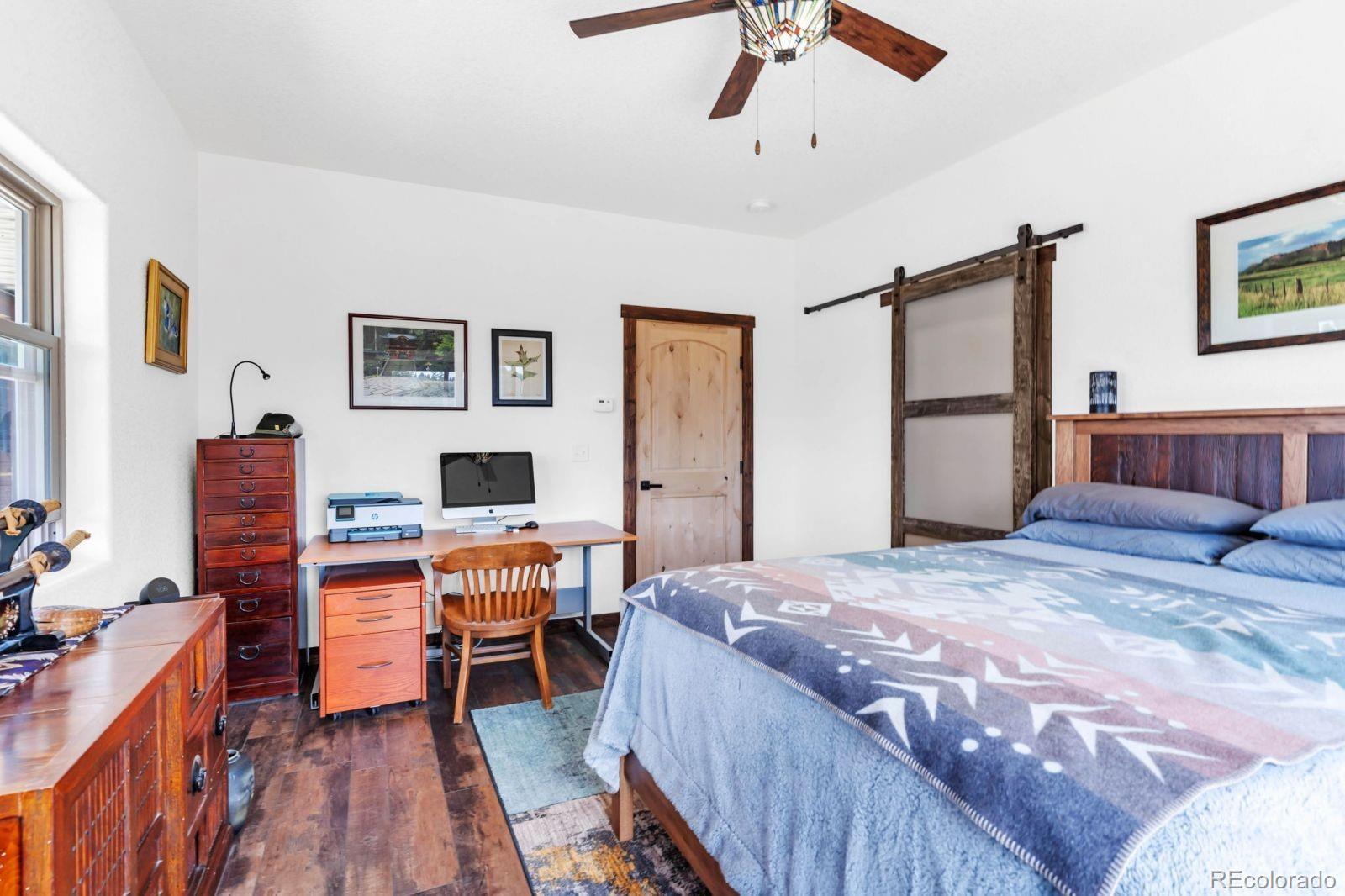 780 County Road 326 Westcliffe, CO 81252 - Photo 11 of 35 a bedroom with a bed and a desk