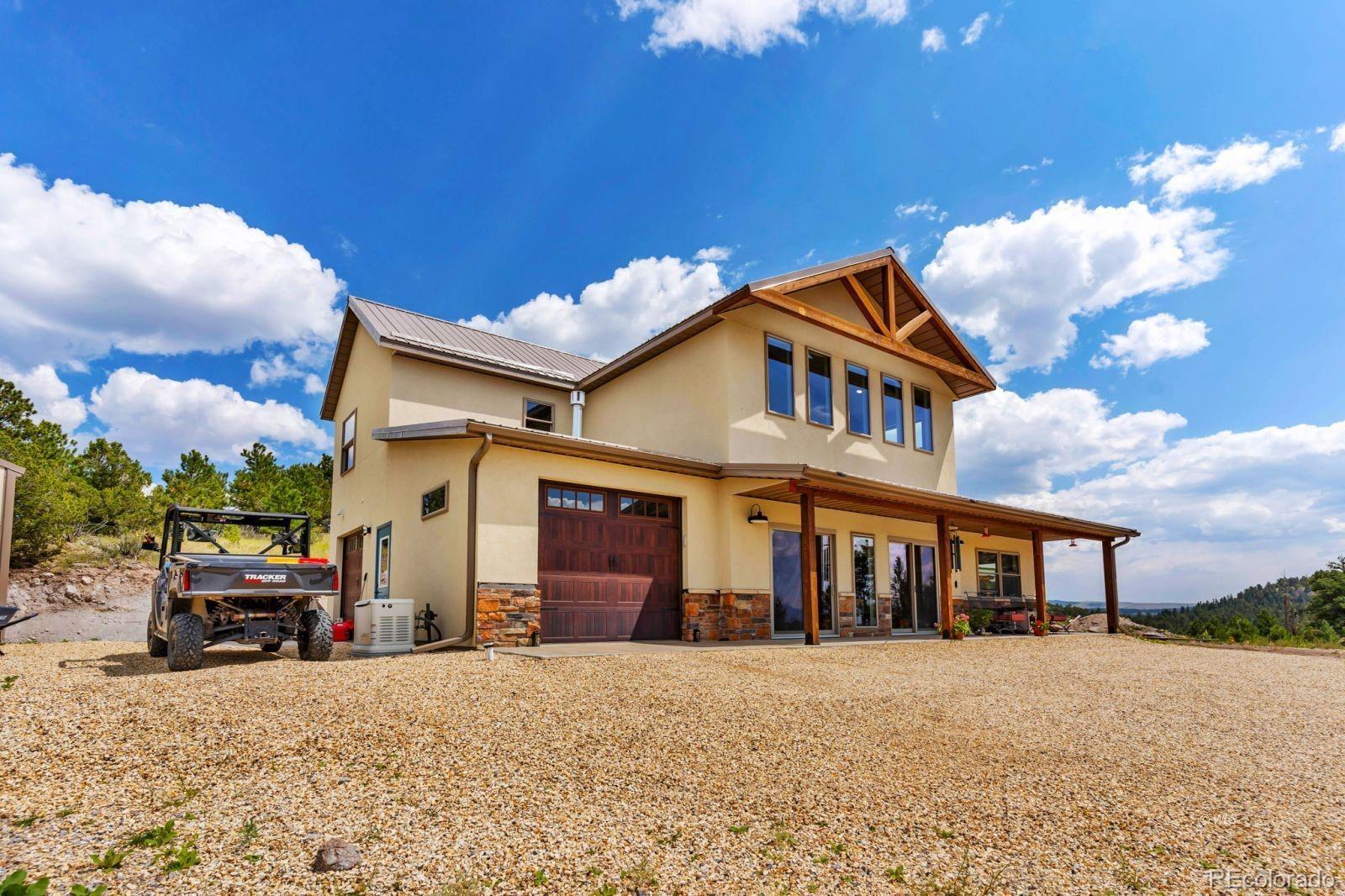 780 County Road 326 Westcliffe, CO 81252 - Photo 2 of 35 a front view of a house with a garden and parking
