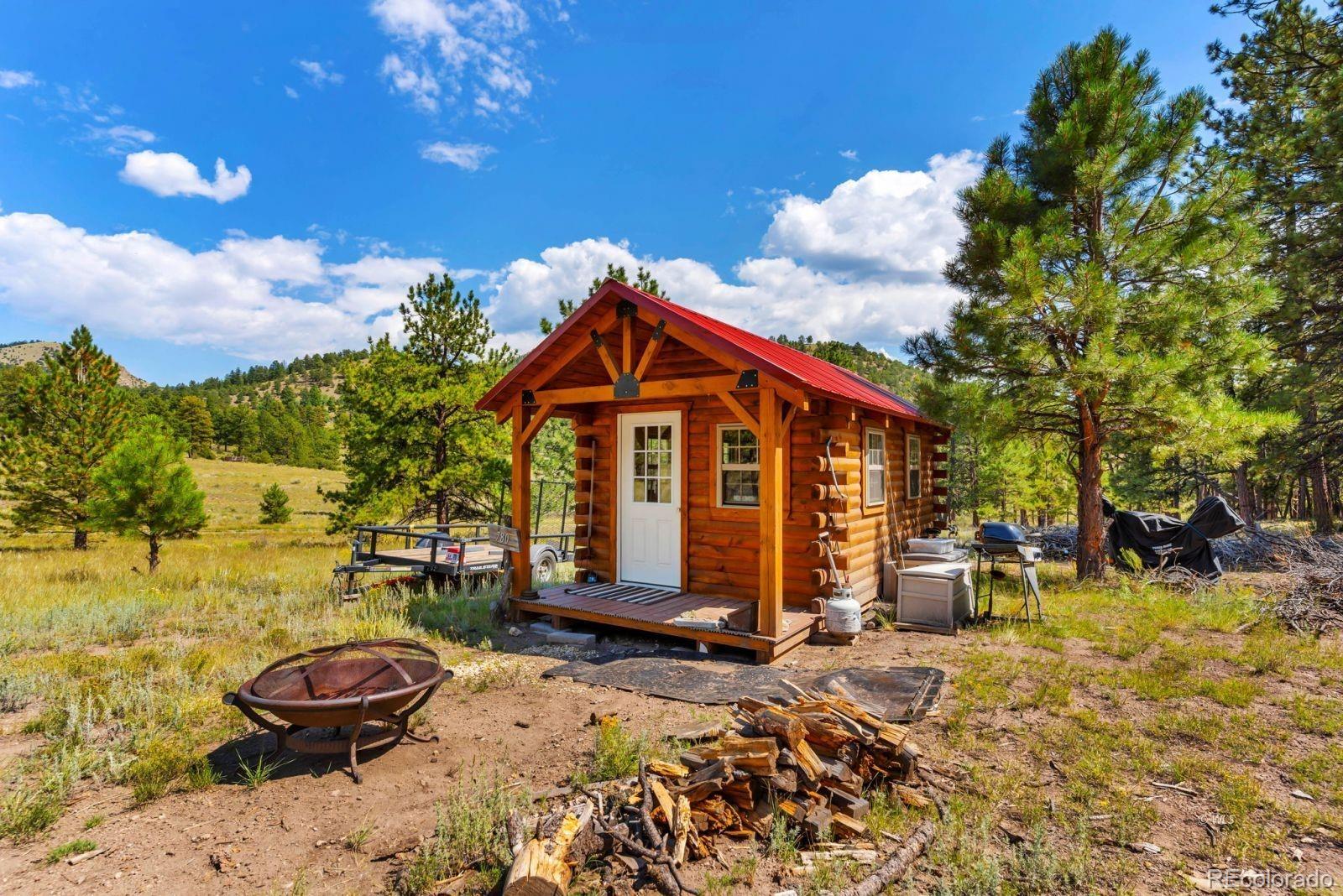 780 County Road 326 Westcliffe, CO 81252 - Photo 26 of 35 a backyard of a house with barbeque oven table and chairs