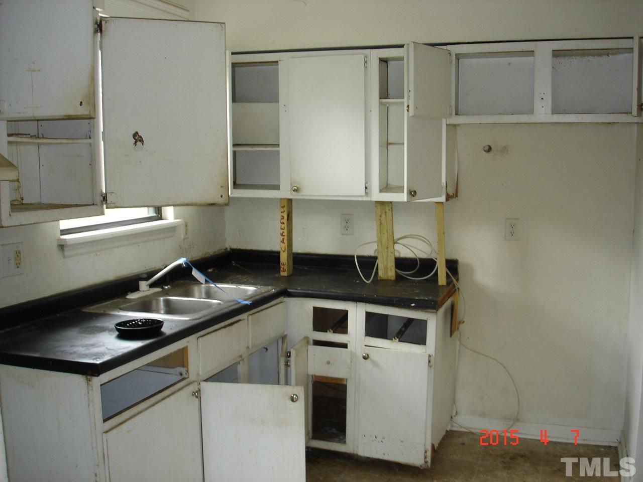 212 Bladen Street Raleigh, NC 27601 - Photo 4 of 9 a kitchen with a sink and a refrigerator