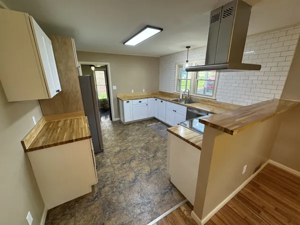 a kitchen with sink refrigerator and stove