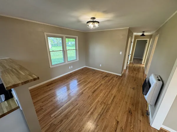 wooden floor in an empty room with a window