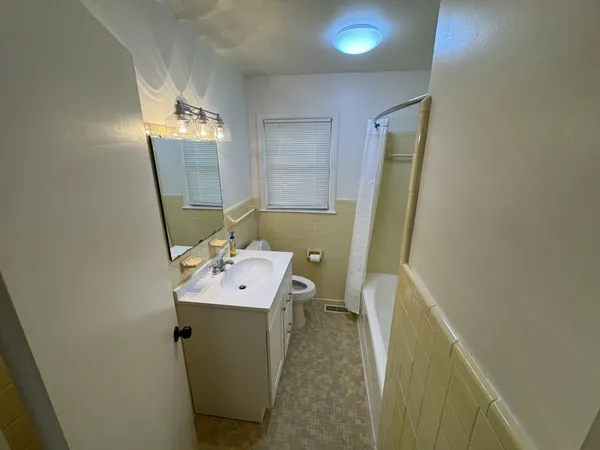 a bathroom with a sink toilet and mirror