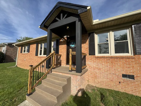 a view of a house with wooden floor and a small yard