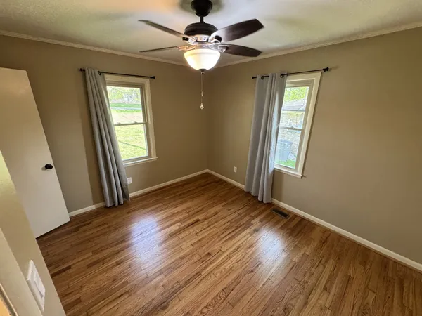 wooden floor in an empty room with a window