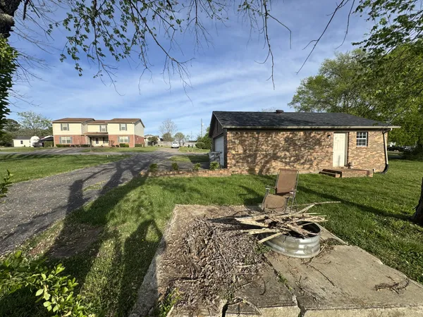 a view of a backyard with sitting area
