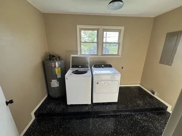 a utility room with sink dryer and washer