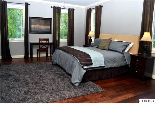 911 Tilman Road Charlottesville, VA 22901 - Photo 12 of 25 a bed sitting in a bedroom next to a window
