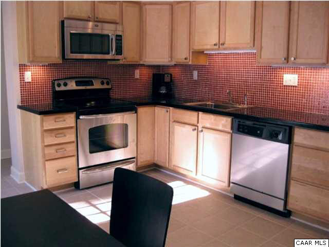 911 Tilman Road Charlottesville, VA 22901 - Photo 15 of 25 a kitchen with stainless steel appliances a stove microwave and cabinets