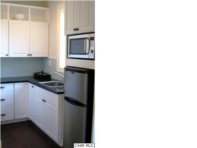 911 Tilman Road Charlottesville, VA 22901 - Photo 17 of 25 a kitchen with a refrigerator and cabinets