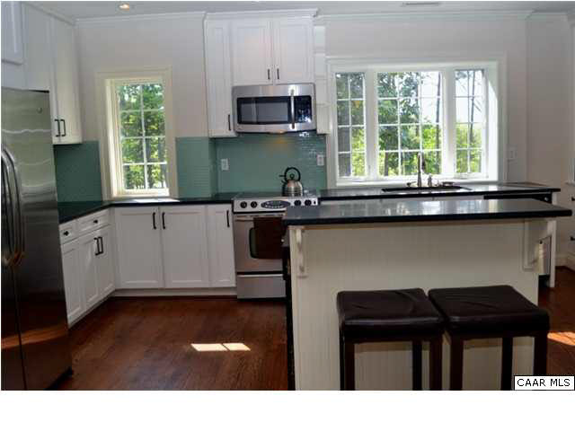 911 Tilman Road Charlottesville, VA 22901 - Photo 8 of 25 a kitchen with granite countertop a stove a sink and a microwave