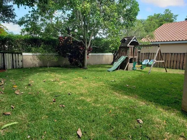 a view of a backyard with a large tree