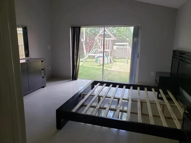 a bathroom with a granite countertop bathtub sink vanity and mirror
