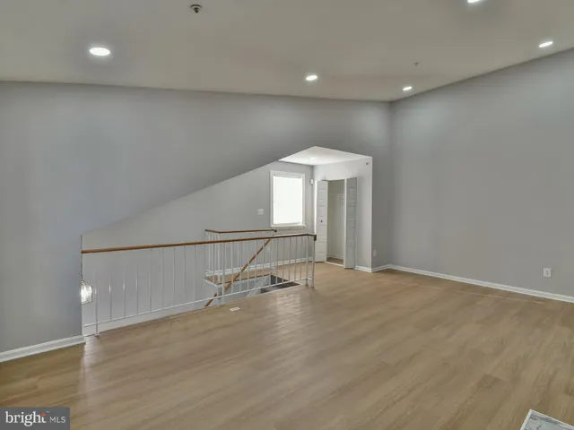 a kitchen with granite countertop a refrigerator and a stove top oven