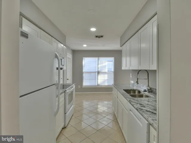 a kitchen with sink cabinets and window