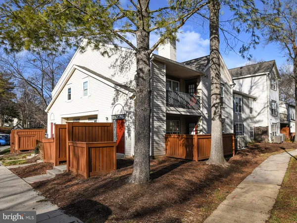 a view of a house with wooden fence