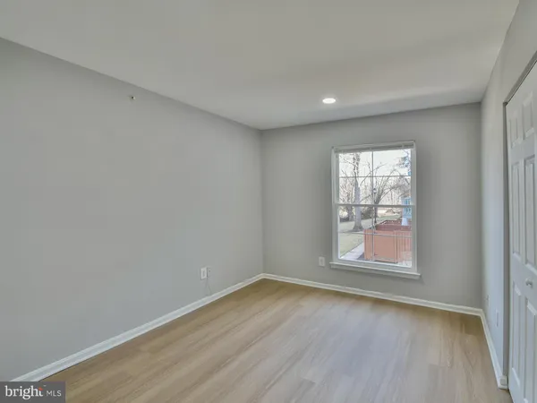 a bedroom with furniture and a wooden floor