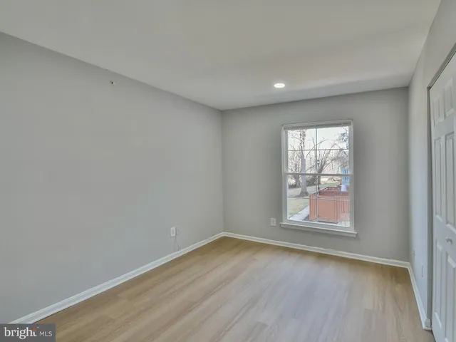 a bedroom with furniture and a wooden floor