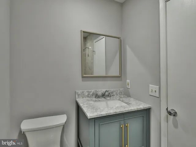 a bathroom with a glass door shower and a sink