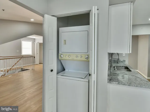 a view of backyard with barbeque grill and wooden fence
