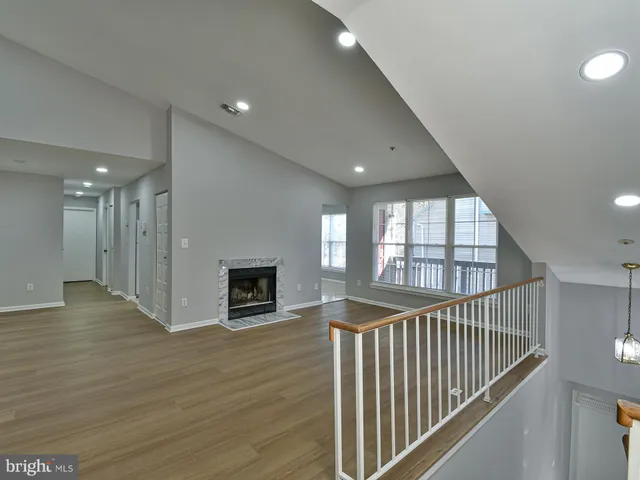 wooden floor in an empty room with a fireplace