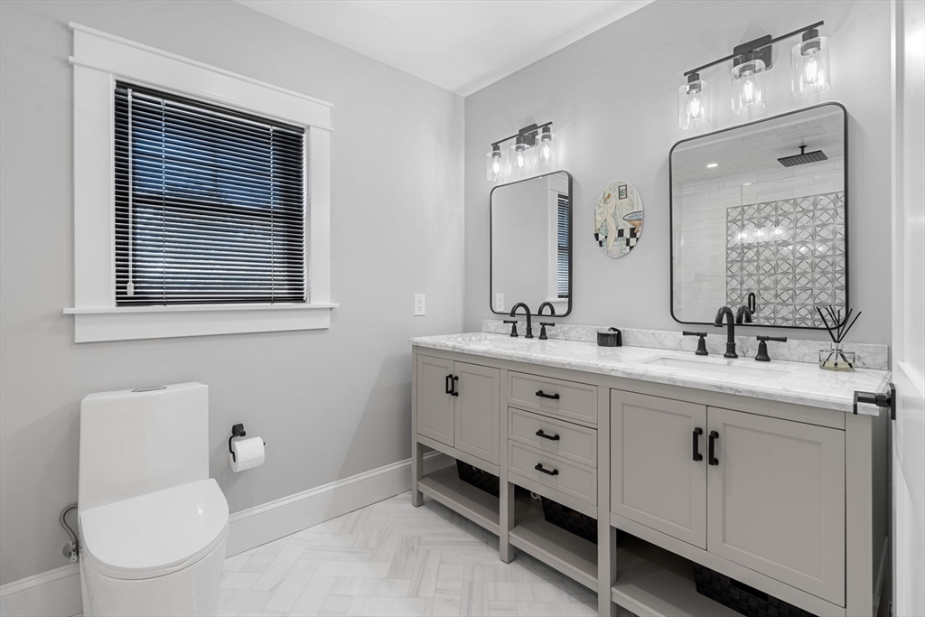 182 High Road Newbury, MA 01951 - Photo 19 of 42 a bathroom with a double vanity sink a toilet and a mirror