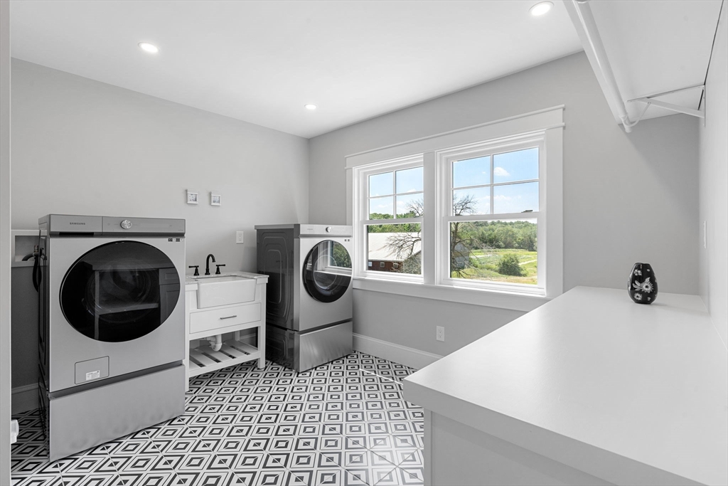 182 High Road Newbury, MA 01951 - Photo 28 of 42 a bathroom with a sink a washer and dryer