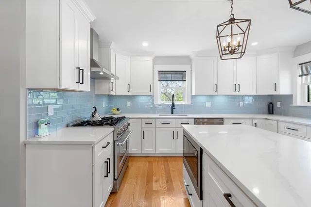 a kitchen with a stove a sink and a refrigerator