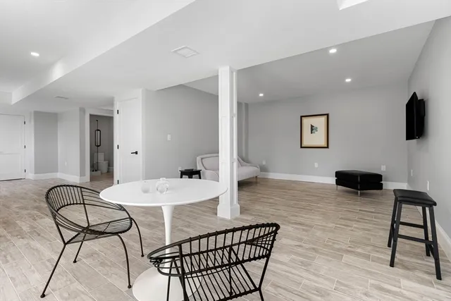 a living room with furniture a flat screen tv and a table