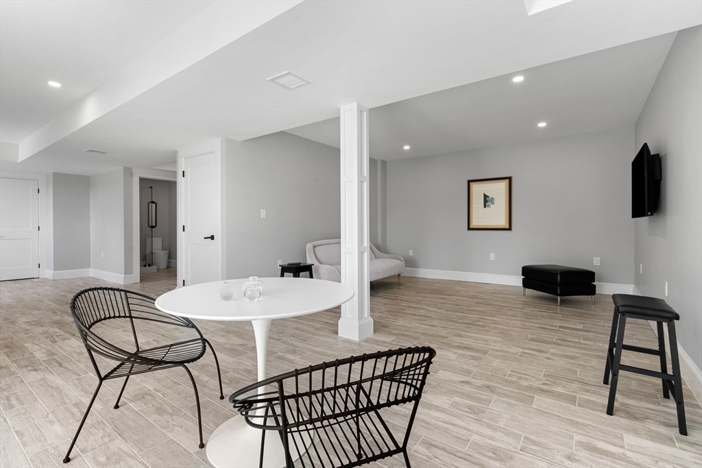 182 High Road Newbury, MA 01951 - Photo 32 of 42 a living room with furniture a flat screen tv and a table