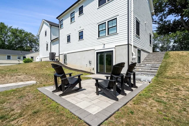 a view of a house with backyard and sitting area