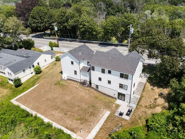 an aerial view of residential house with outdoor space and trees around