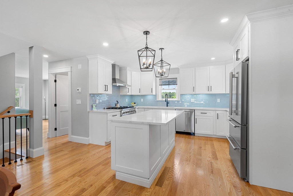 182 High Road Newbury, MA 01951 - Photo 6 of 42 a large kitchen with a center island wooden floor stainless steel appliances and cabinets