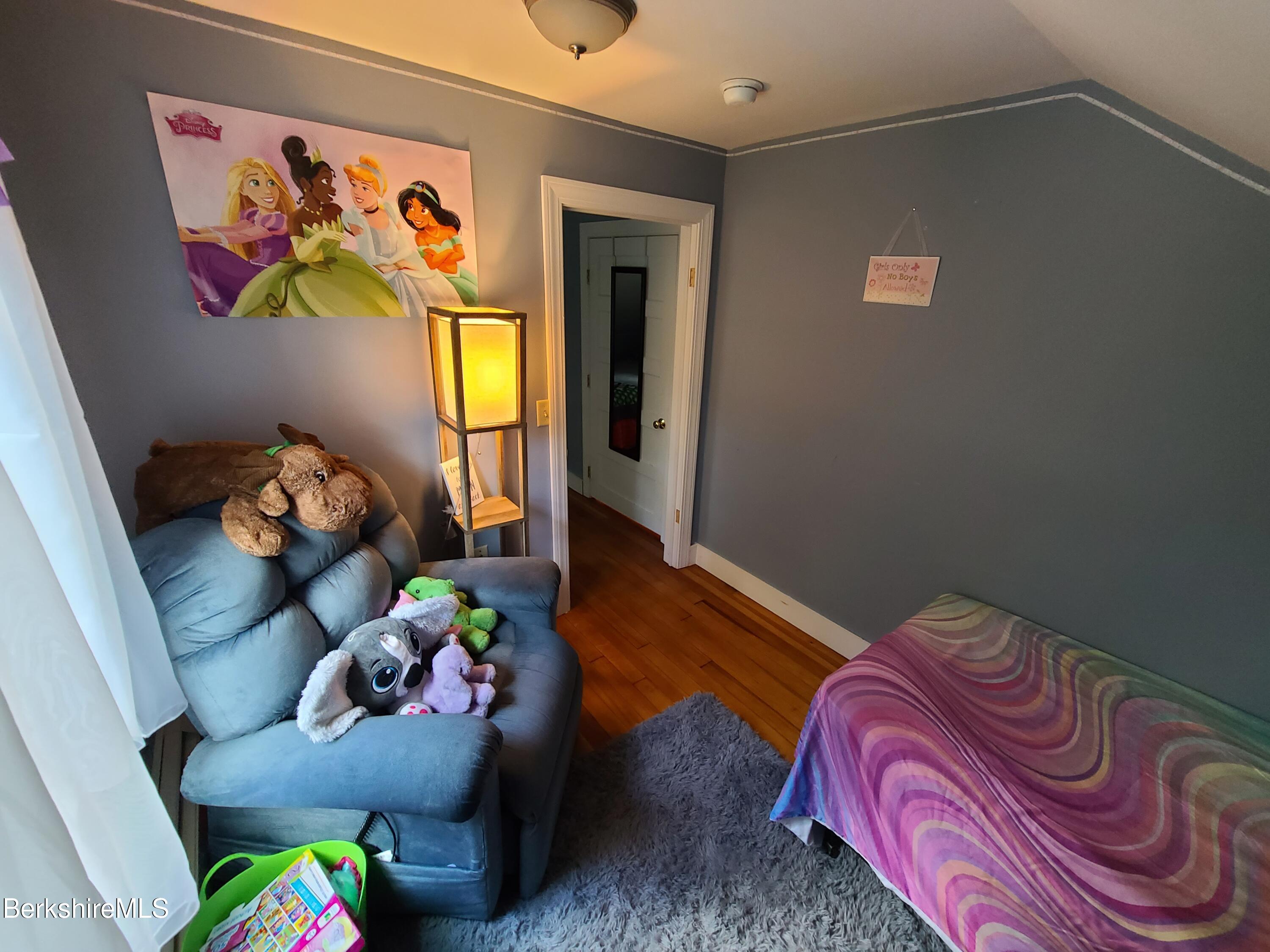 164 Cross Road Clarksburg, MA 01247 - Photo 16 of 22 a bed room with a bed and a painting on the wall