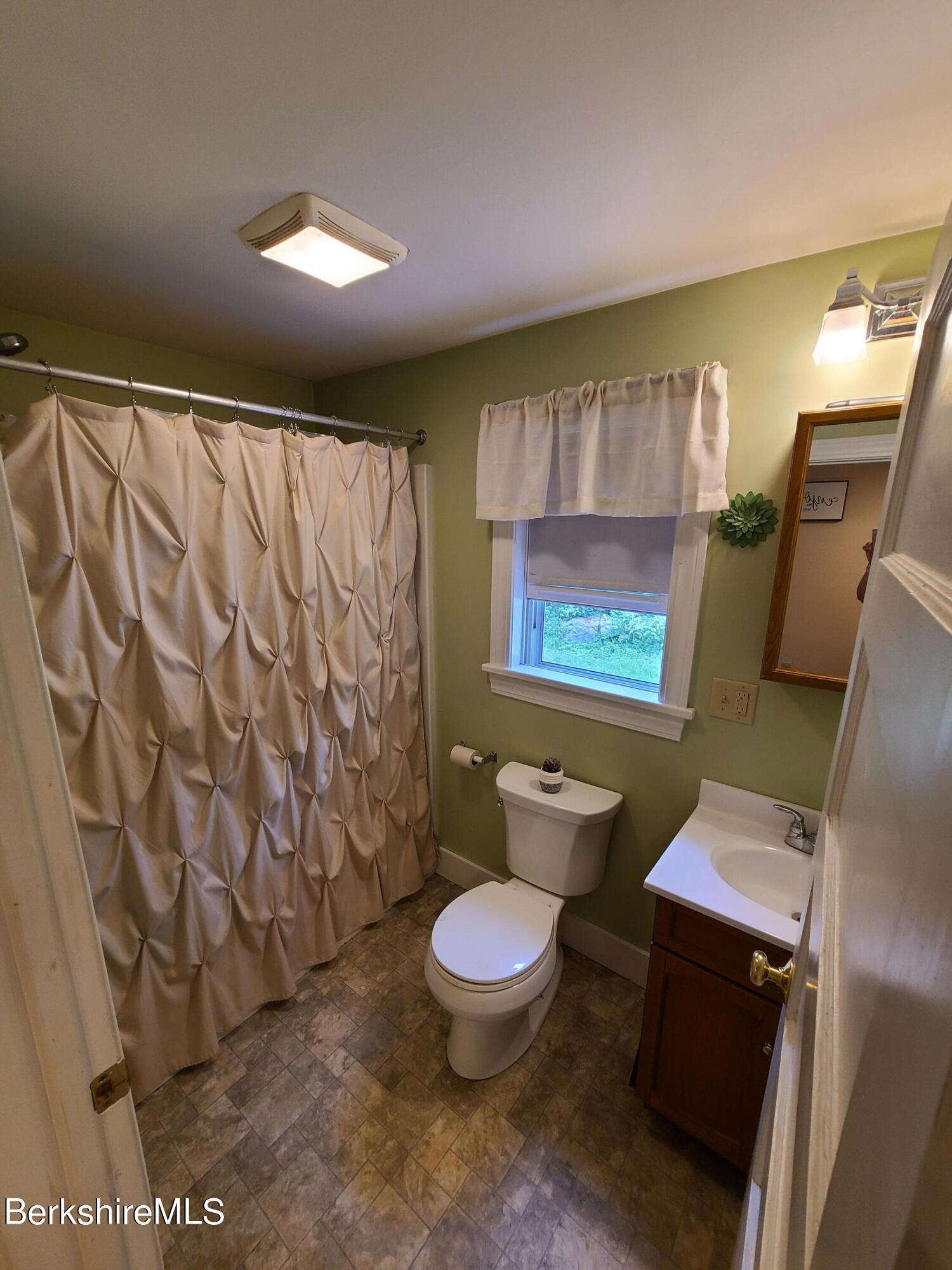 164 Cross Road Clarksburg, MA 01247 - Photo 9 of 22 a bathroom with a toilet sink and shower curtain