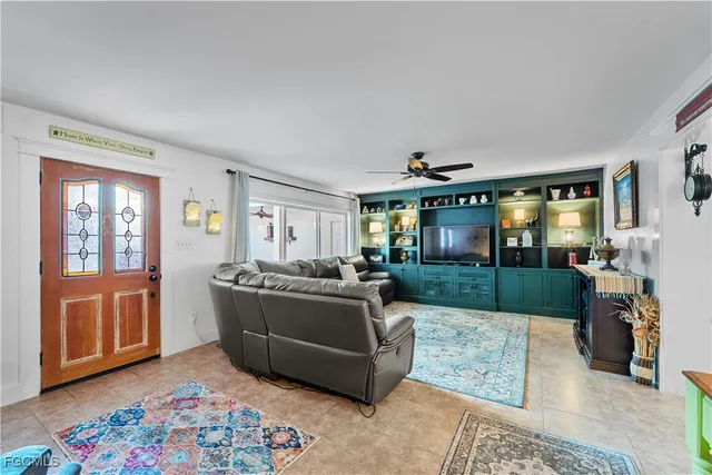 a living room with furniture fireplace and a window