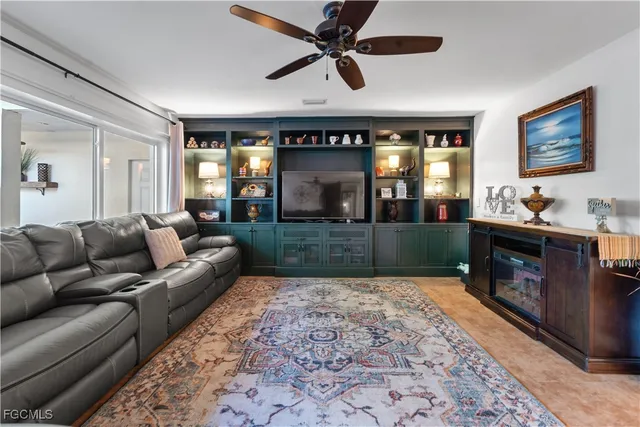a living room with furniture a clock on wall and a window