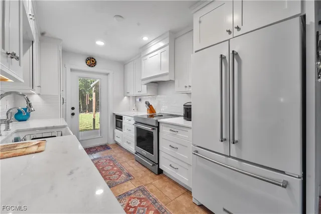 a kitchen with stainless steel appliances granite countertop a sink and a cabinets