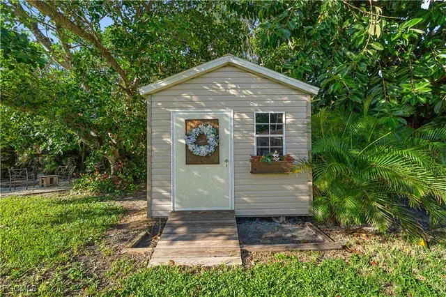 a view of a house with backyard porch and sitting area