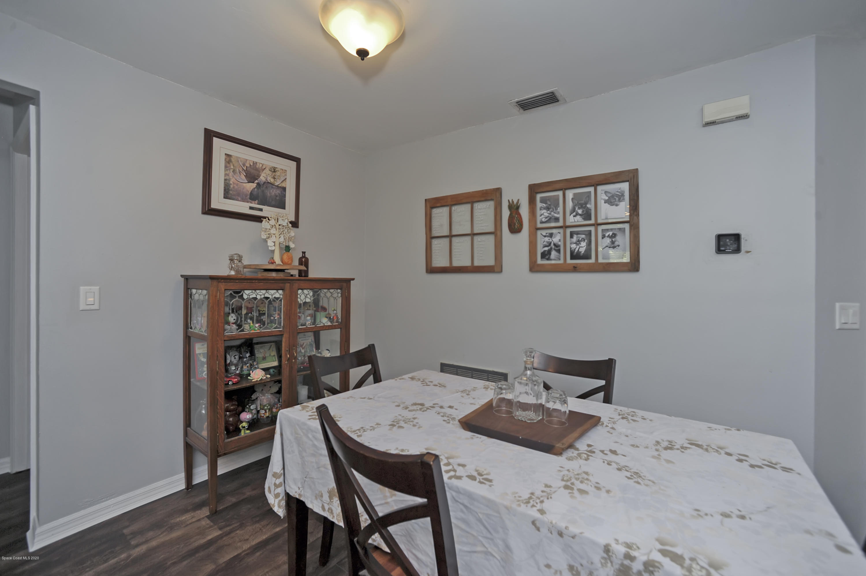 877 Walpole Road Southwest Palm Bay, FL 32908 - Photo 11 of 27 a bedroom with a bed and a bookshelf
