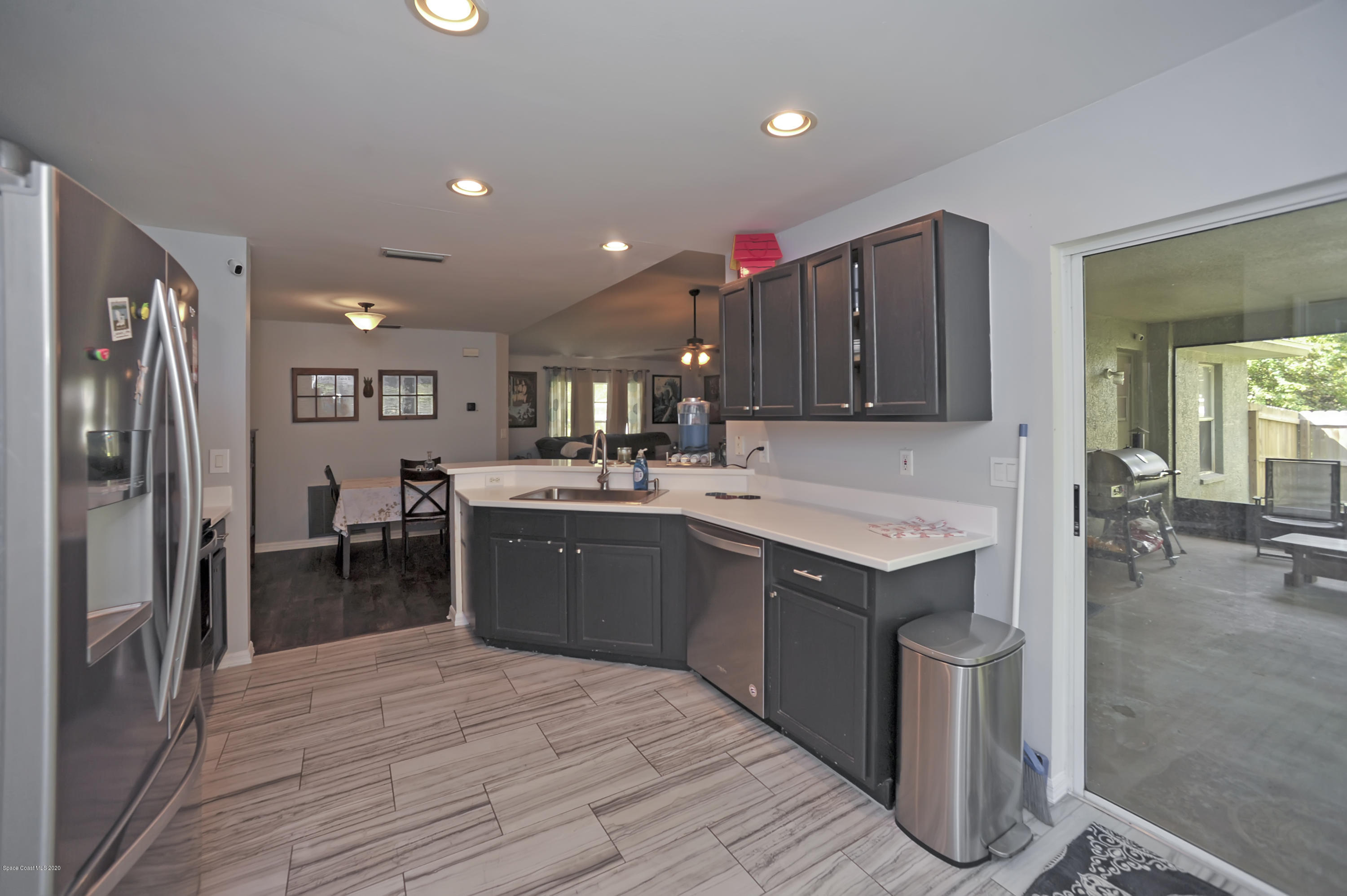 877 Walpole Road Southwest Palm Bay, FL 32908 - Photo 12 of 27 a kitchen with a sink refrigerator and cabinets