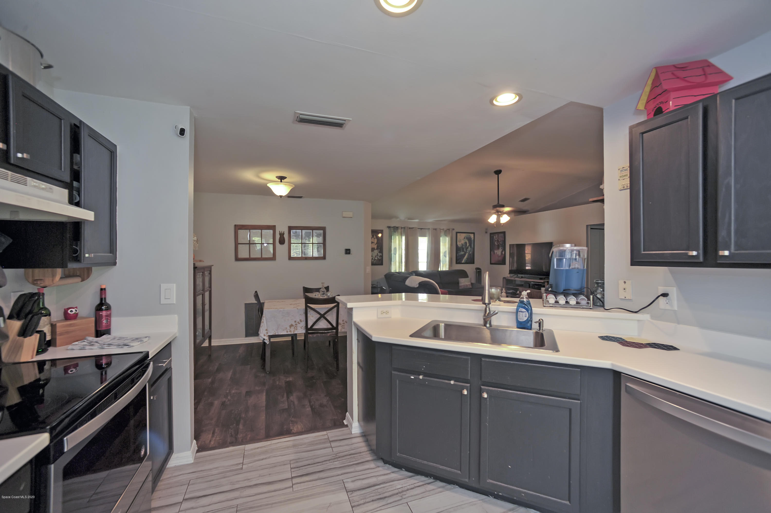 877 Walpole Road Southwest Palm Bay, FL 32908 - Photo 14 of 27 a kitchen with a sink stove and cabinets