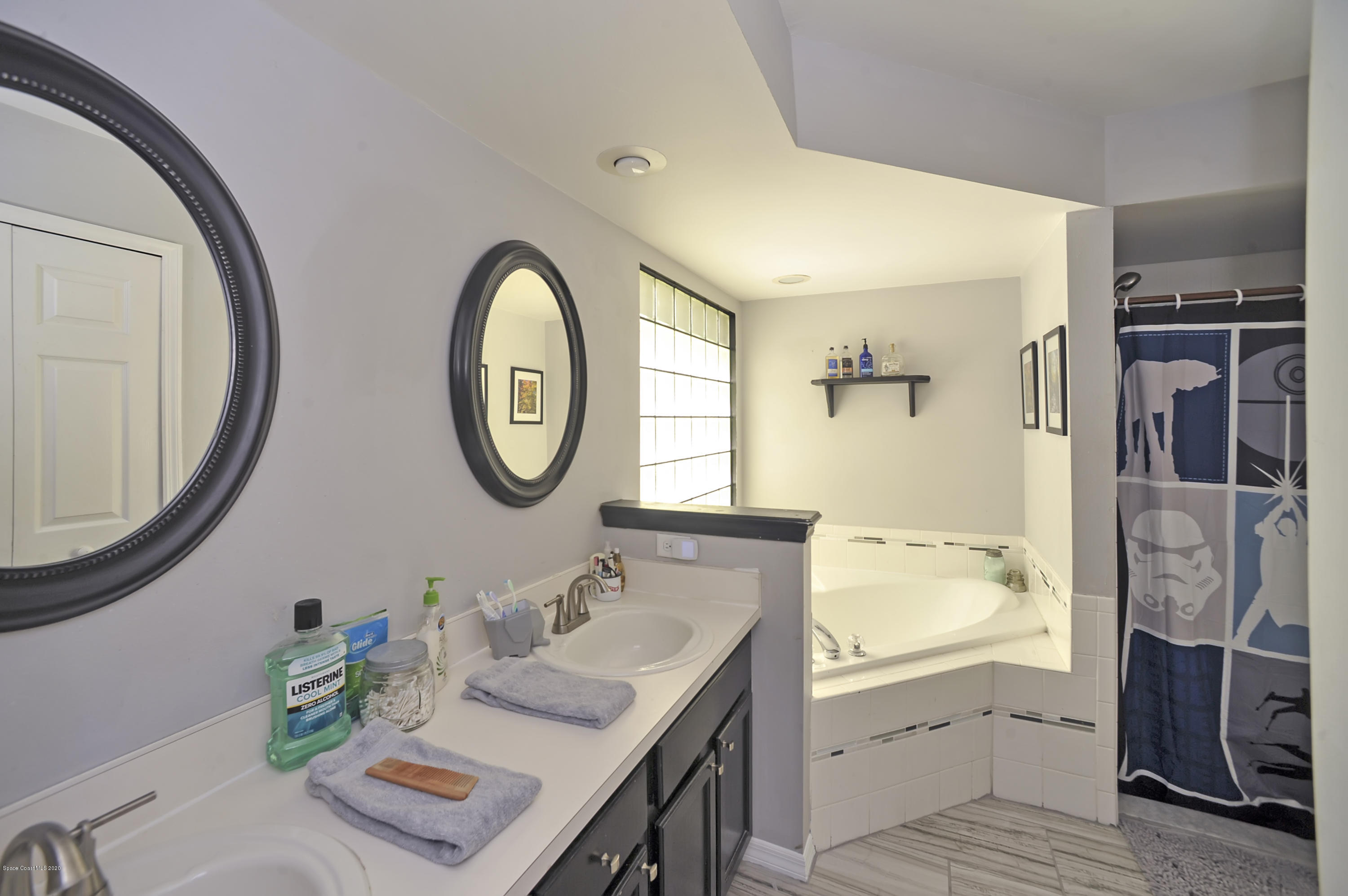877 Walpole Road Southwest Palm Bay, FL 32908 - Photo 19 of 27 a bathroom with a granite countertop sink and a mirror
