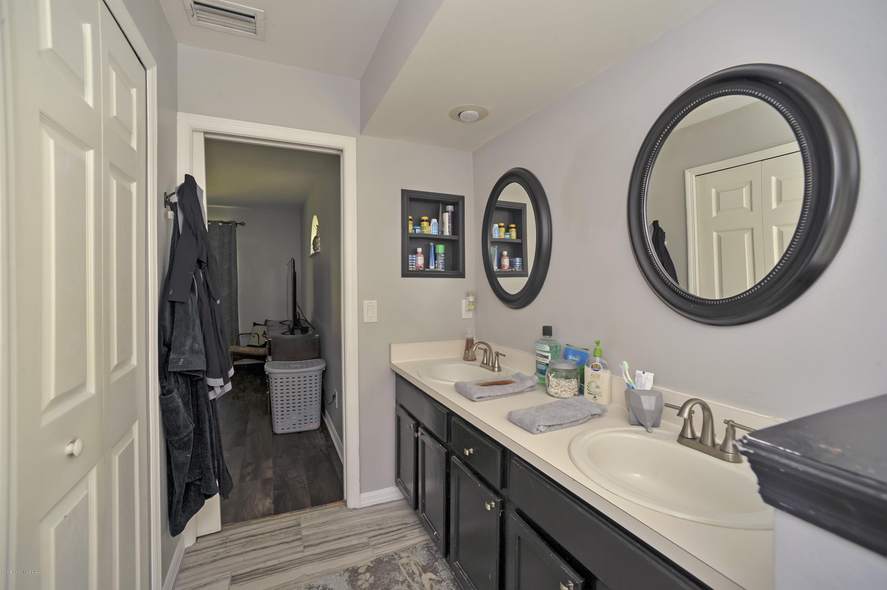 877 Walpole Road Southwest Palm Bay, FL 32908 - Photo 20 of 27 a bathroom with a double vanity sink and a mirror