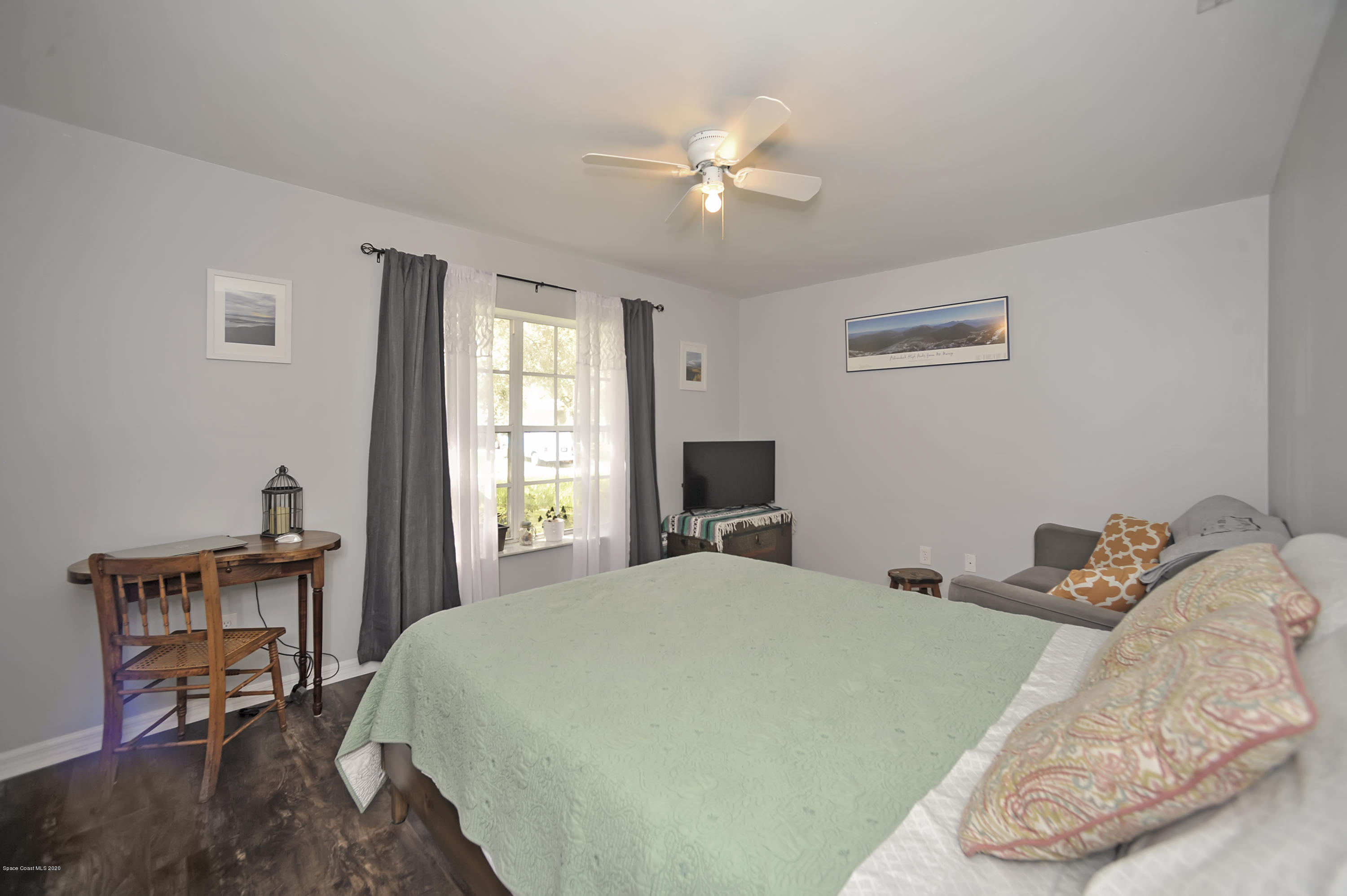 877 Walpole Road Southwest Palm Bay, FL 32908 - Photo 21 of 27 a bedroom with a bed and a chandelier