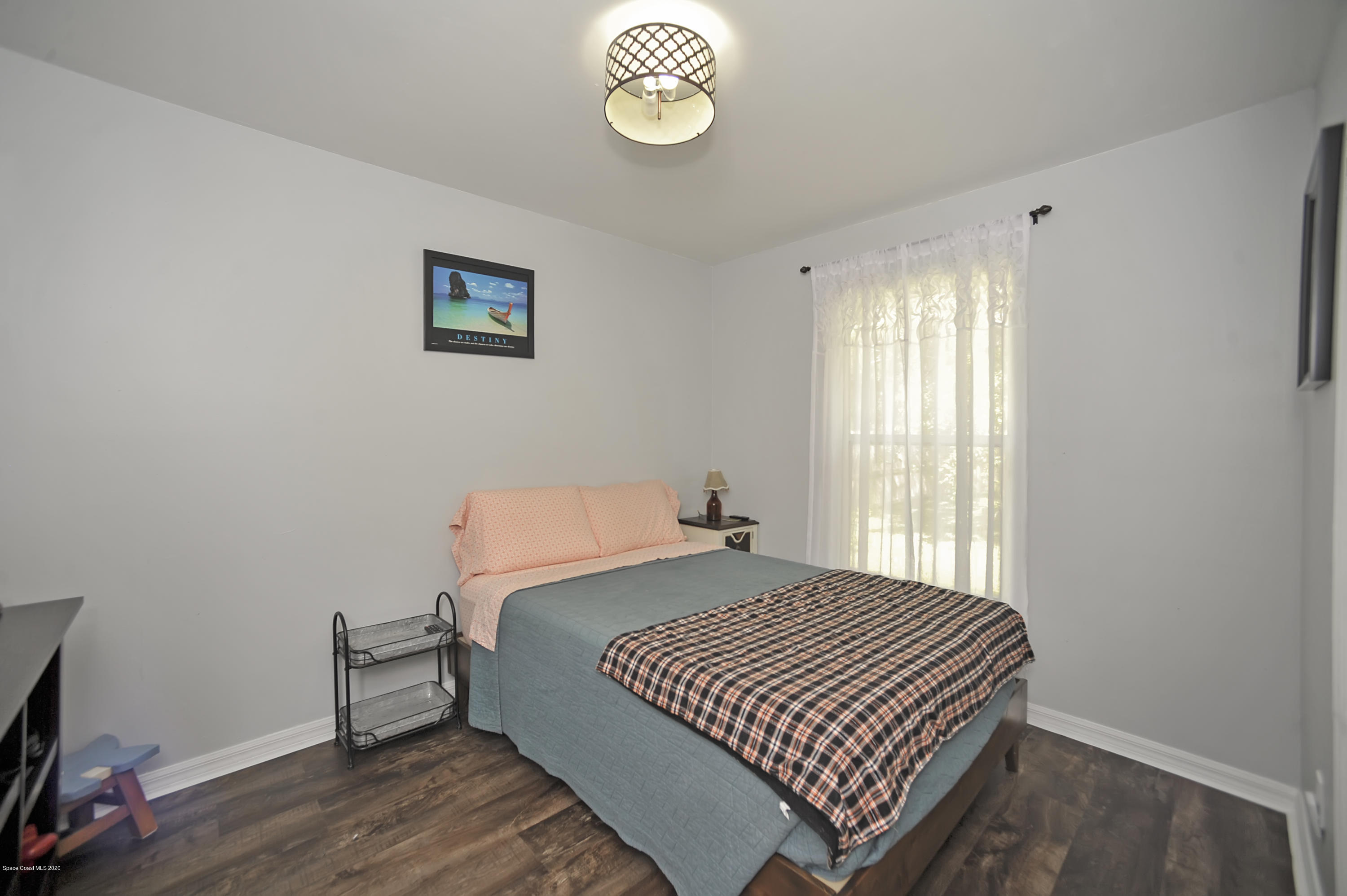 877 Walpole Road Southwest Palm Bay, FL 32908 - Photo 22 of 27 a bedroom with a bed and a window