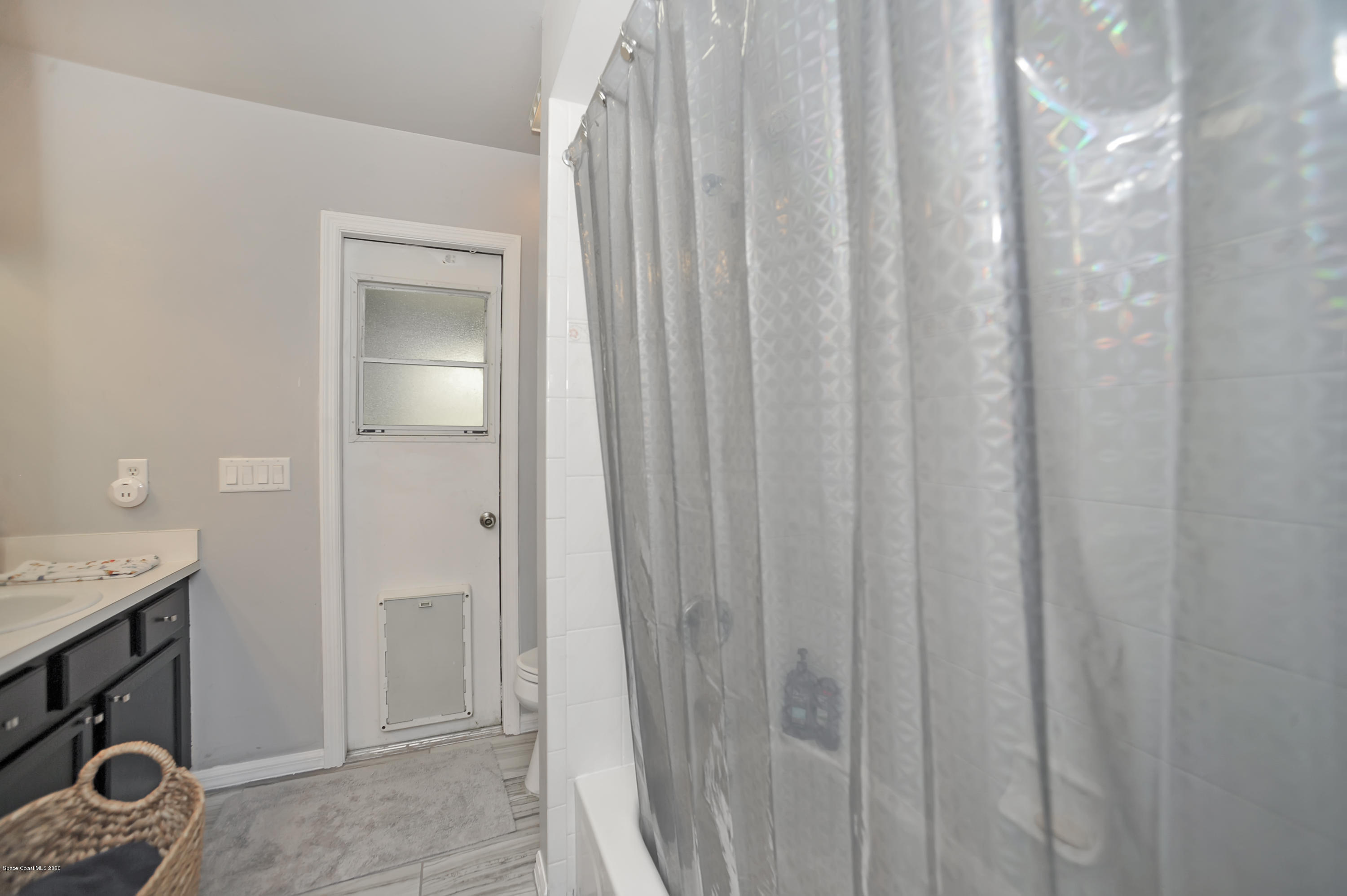 877 Walpole Road Southwest Palm Bay, FL 32908 - Photo 23 of 27 a view of a bathroom from a hallway