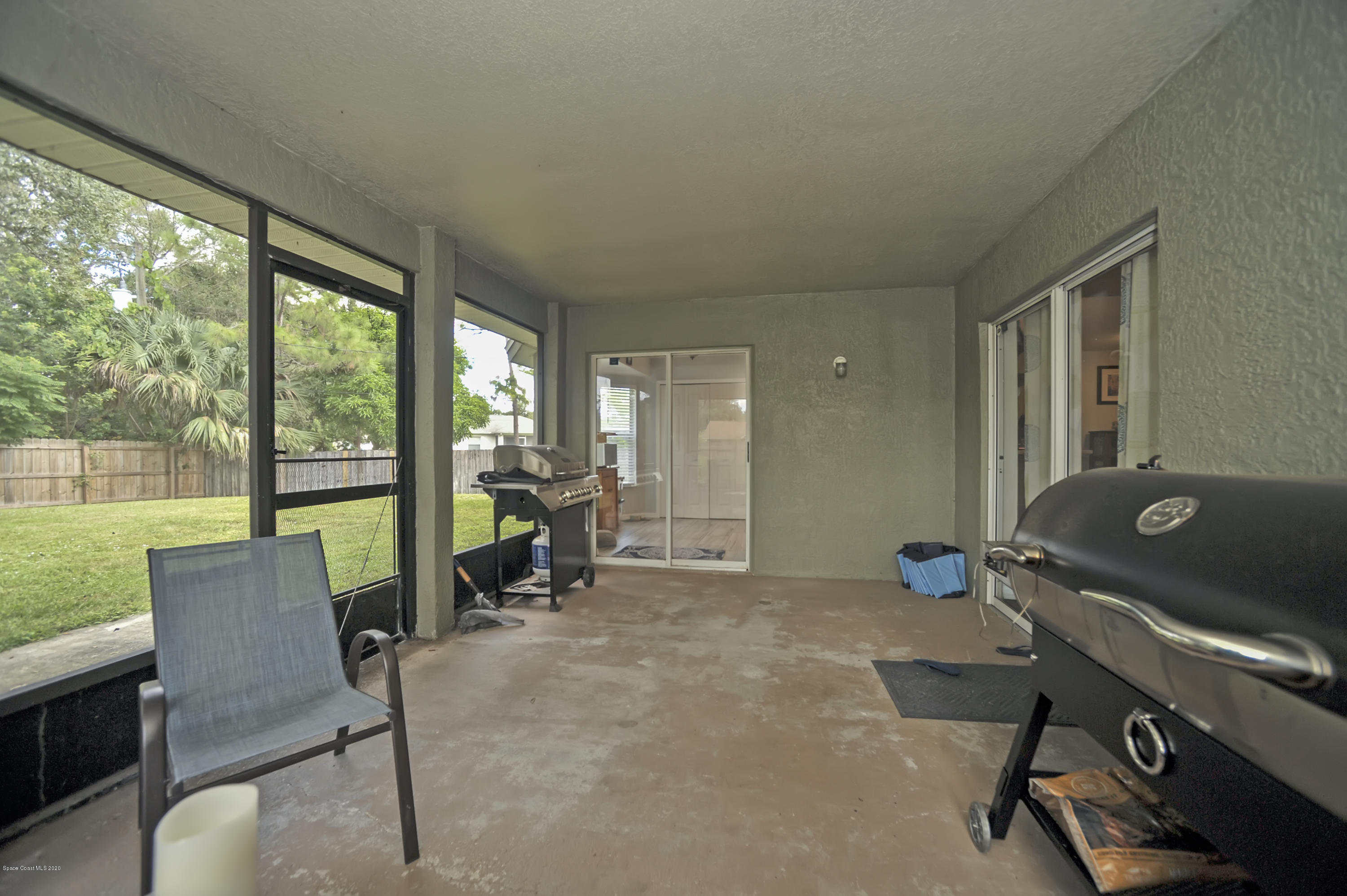 877 Walpole Road Southwest Palm Bay, FL 32908 - Photo 24 of 27 a room with furniture and a floor to ceiling window