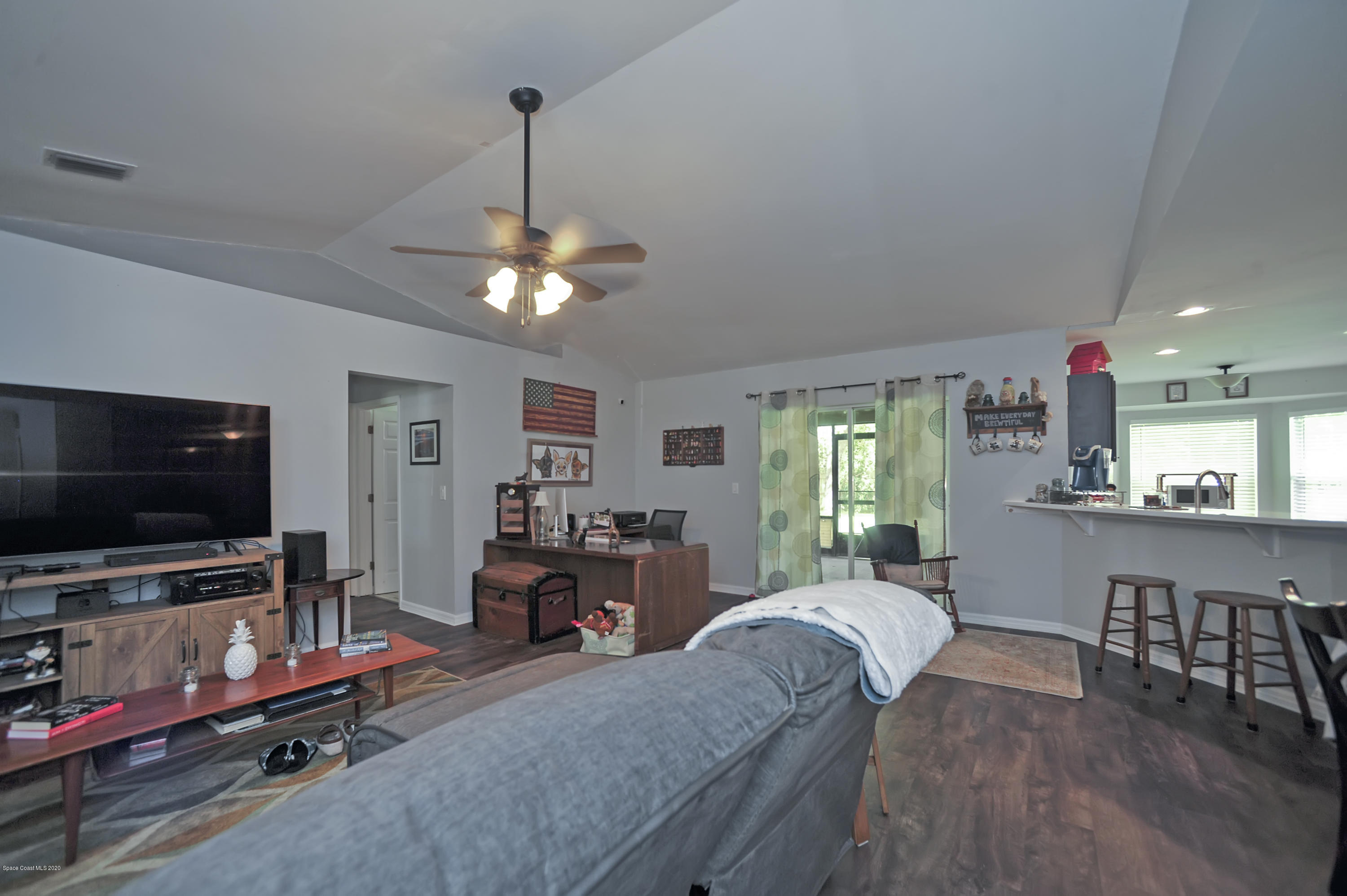 877 Walpole Road Southwest Palm Bay, FL 32908 - Photo 7 of 27 a living room with furniture and a flat screen tv